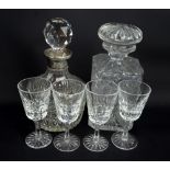 A clear cut glass square sectioned decanter and a silver collared example,