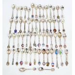 A large collection of predominantly hallmarked silver souvenir spoons with enamel detailed finials