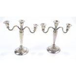 A pair of miniature white metal candelabra with inverted baluster stems, unmarked, height 9cm,