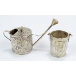 A late 19th century Dutch miniature watering can overall embossed with pastoral scenes amongst