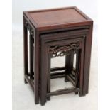 A Chinese rosewood nest of four tables with pierced scrolled decoration, width of largest 45cm.