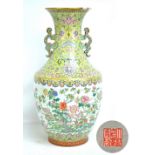 A large Chinese porcelain vase of baluster form with flared rim and pierced stylised dragon handles,