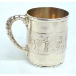 TIFFANY & CO; a sterling silver 'Children's Parade' pattern christening mug with scroll handle,