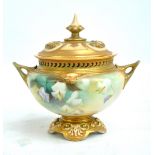 A Royal Worcester hand painted gilt heightened twin handled potpourri bowl and cover,