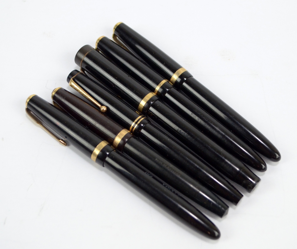 A collection of black Parker cartridge and fountain pens including Victory,