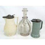 A Humphrey Taylor quartered glass decanter, height 26cm, and two stoneware jugs (3).