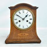 An Edwardian inlaid oak eight day mantel clock, height 30.5cm.