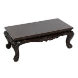 A Chinese hardwood opium table with carved dragon detail on four outswept supports, length 81cm.