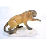 A Beswick matt glazed figure, panther on a rock, impressed no.1702, length 31cm.