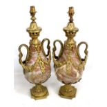 A pair of brass mounted marble twin handled lamps with baluster shaped bodies stylised swan neck