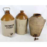 Three large stoneware storage jars, two with metal taps, height 40cm (3).