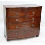 An early 19th century mahogany bowfronted chest of two short and three long drawers.