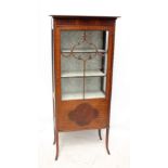 An Edwardian mahogany display cabinet with three quarter glazed and quarter panelled single door