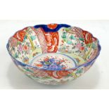 An early 20th century Chinese footed bowl with shaped rim and floral decoration, unmarked to base,