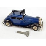 A Tri-ang Mimic Toys clockwork car with horn on roof and internal driver and passenger,