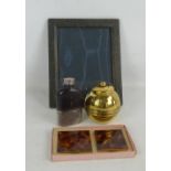 A hip flask with glass body and stitched leather upper section, a photograph frame,