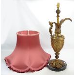 A brass lamp base in the form of a ewer with figural decoration on circular marble base,