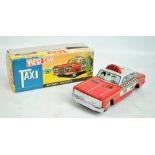 A boxed ME Shanghai 629 red cab taxi battery and coin operated tinplate car, length 26cm.