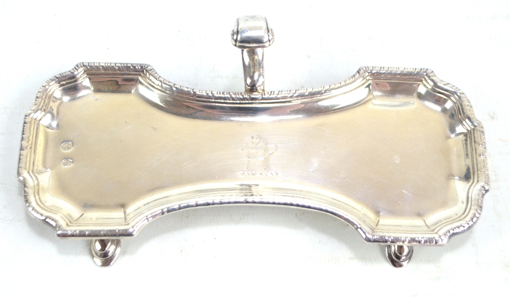 An 18th century Irish hallmarked silver candle snuffer tray with c-scroll central handle,