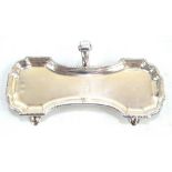 An 18th century Irish hallmarked silver candle snuffer tray with c-scroll central handle,