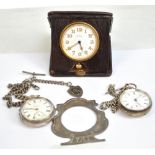 A leather cased Swiss eight day travel clock set with Arabic numerals and with detachable George V