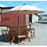 A garden bar, two high and two low stools, a low table and parasol with stand.