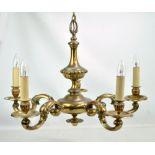 A decorative brass five branch ceiling light with circular drip pans.