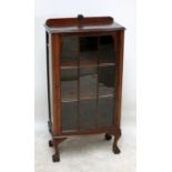 An early 20th century mahogany display cabinet with glazed door enclosing three shelves,
