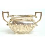 CHARLES HORNER; a George V hallmarked silver twin handled sugar bowl with part gadrooned decoration,