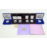 A small group of Lady Diana themed coins comprising two cased 925 silver proof memorial coins with