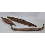 A South Sea Islands carved wooden canoe, decorated with cowrie shells, length 87cm,