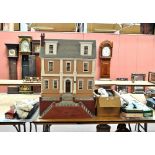 A large Victorian style doll's house with hinged front and one side of the roof with sash windows,