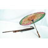 An early 20th century hallmarked silver mounted bamboo walking stick and two paper parasols (3).