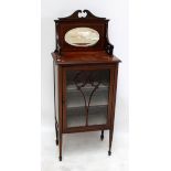 An Edwardian mahogany and inlaid display cabinet with mirrored upper section above single glazed