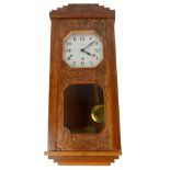 An Art Deco French carved oak cased Vedette wall clock, height 81cm.