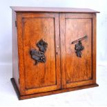 A late 19th century walnut stationery cupboard with pair of panel doors enclosing rack and three