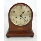 An Edwardian oak and inlaid eight day bracket clock, the silvered dial set with Arabic numerals,