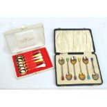 A cased pair of George V hallmarked silver and enamel decorated Art Deco coffee spoons,