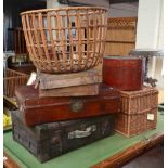 Three suitcases, a wicker log basket,