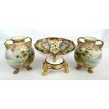 A large Noritake floral decorated twin handled comport on separate circular base with gilt