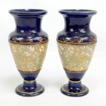 A pair of Doulton Lambeth Slaters Patent decorated footed vases, impressed marks to base,