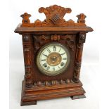 An oak cased Ansonia Clock Co mantel clock, the chapter ring set with Roman numerals, height 32cm.