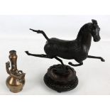 A Chinese bronze modelled as a galloping horse, on carved wooden stand, height 26cm,