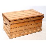 A large old pine tool chest with hinged lid and twin carrying handles, width 113cm.
