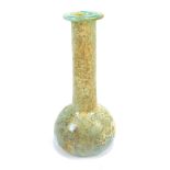 A pale green Roman glass bottle, circa 2nd-3rd century AD, with slender neck and squat body,