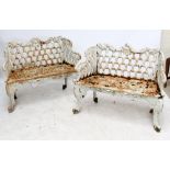 A pair of cast iron garden benches in the 'Rose Garden' pattern, each being two seated,