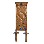 An Arts and Crafts copper and enamel decorated wall sconce,