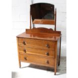 A 1930s oak dressing chest with swing mirror and square legs to metal castors, 149 x 91.5 x 45cm.