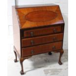 A reproduction mahogany bureau, drop-down desk top with pigeonholes and small drawers to interior,