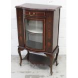 An early-to-mid 20th century bow-front inlaid display cabinet, one central bow-front glazed door,